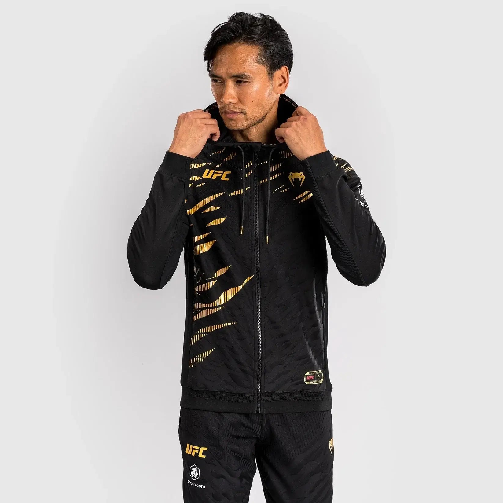 UFC Fusion Authentic Fight Night Walkout Hoodie worn by a model, showcasing its stylish design and performance fabric.