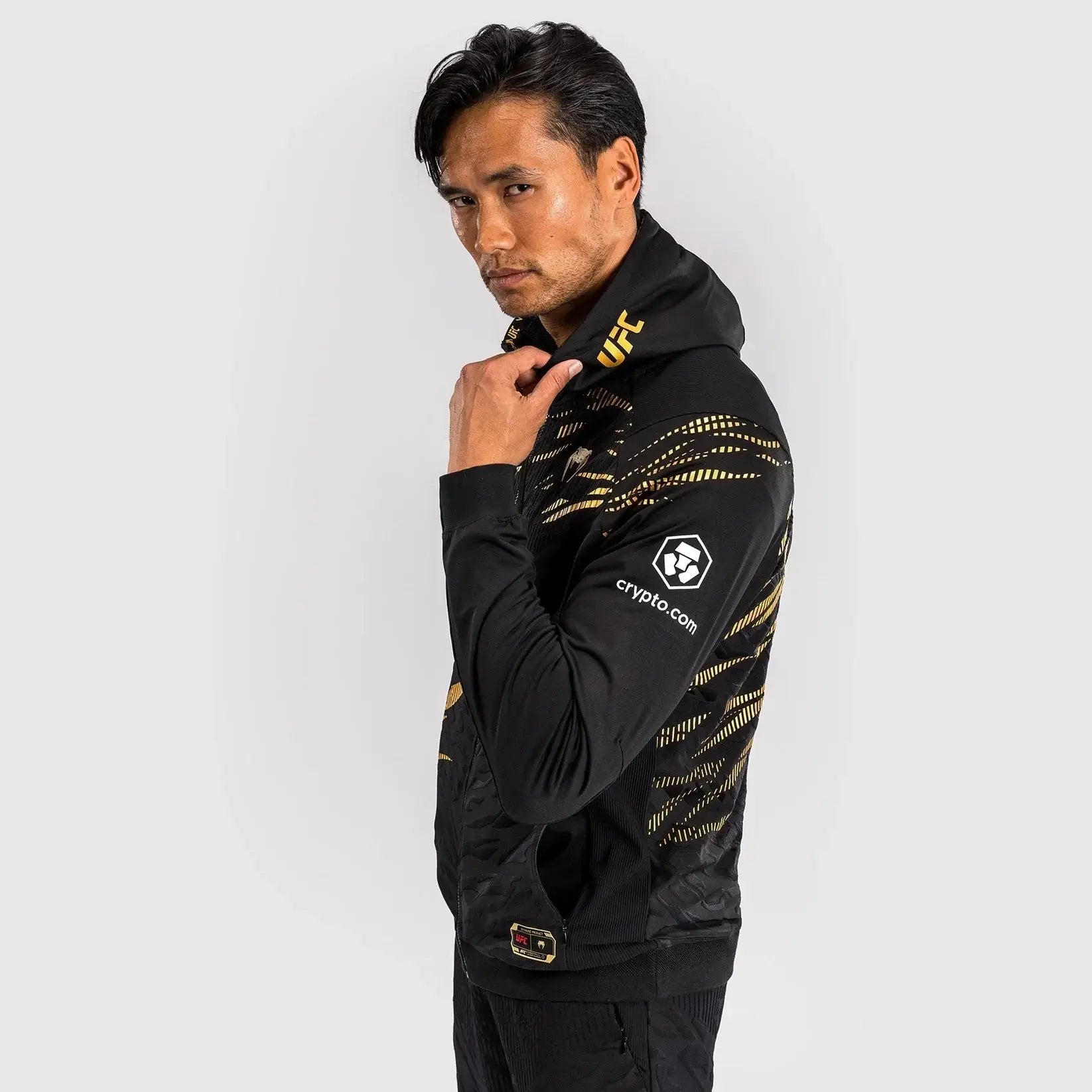 UFC Fusion Authentic Fight Night Walkout Hoodie modeled by a man showcasing its sleek design and performance features.