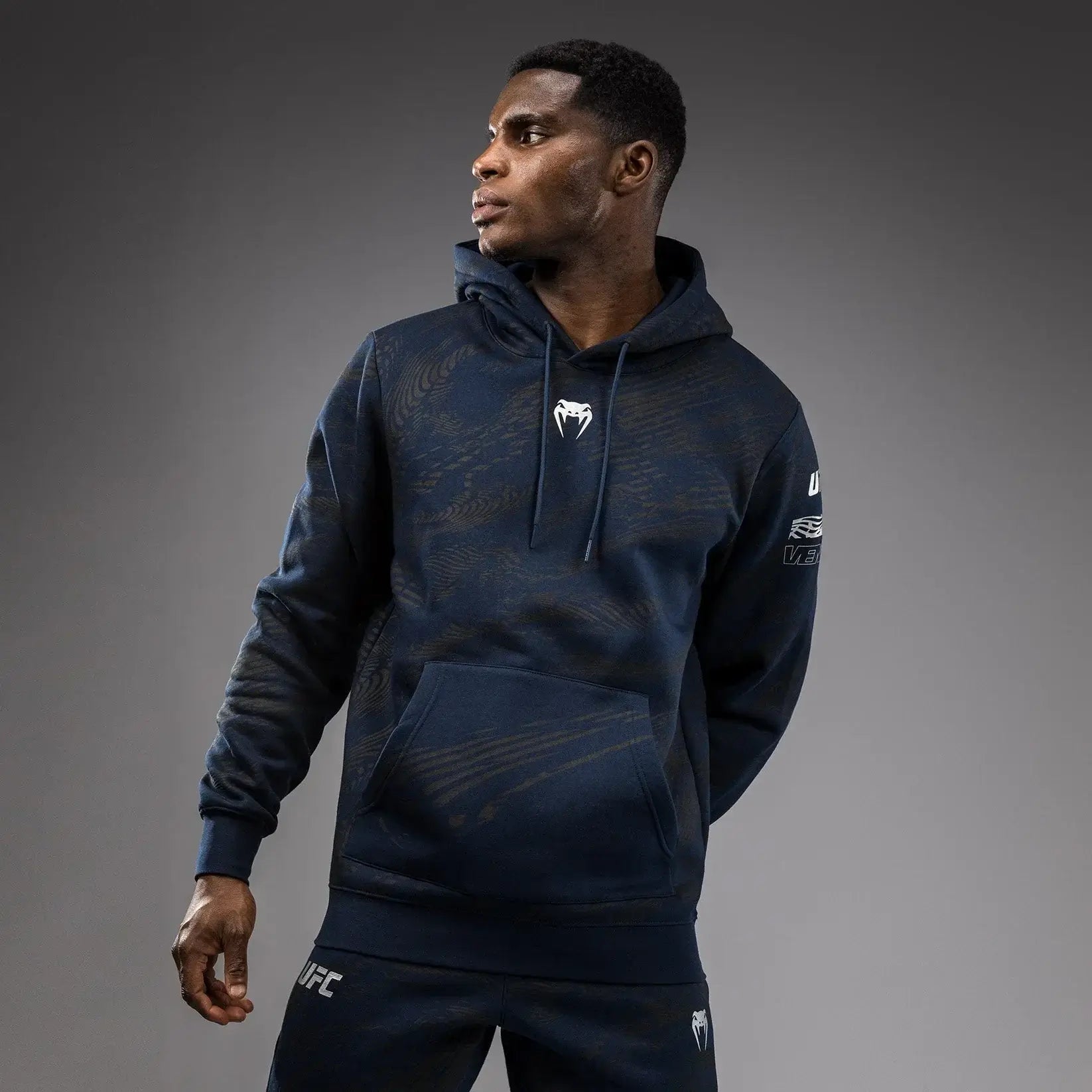 Man wearing UFC Fusion Fight Week Pullover Hoodie with sleek design and performance fabric.