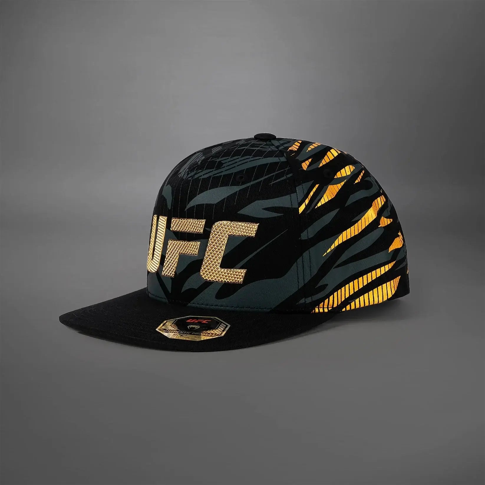 UFC Fusion Authentic Fight Night Snapback Hat with bold design and performance fabrics on a gray background.