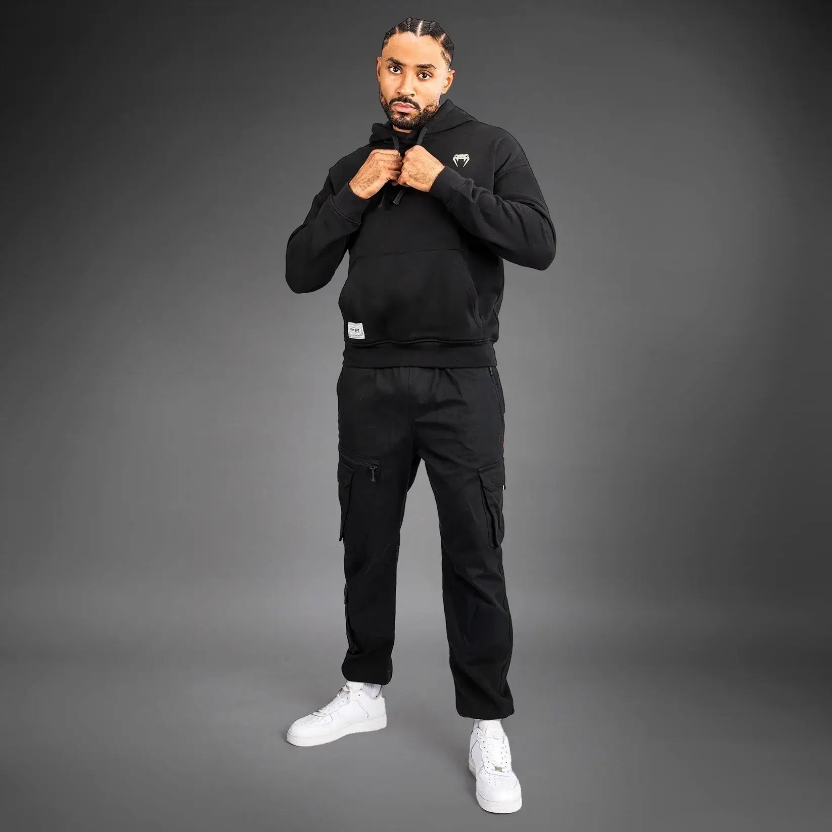 UFC Ulti-Man Competition Hoodie modeled by a man in a black outfit, showcasing the iconic logo and style.