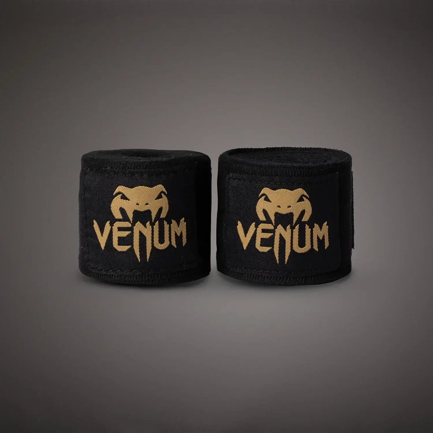 Venum Kontact Boxing Handwraps in black with gold logo on a dark background.